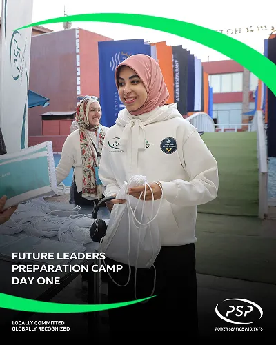 Participant smiling while collecting materials at PSP Future Leaders Preparation Camp.