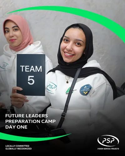 Female participant smiling and holding Team 5 sign at PSP Future Leaders Camp Day One.