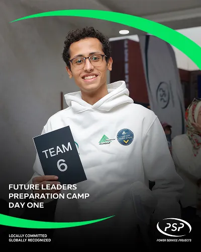 Engineering student with glasses holding Team 6 sign during PSP Future Leaders Camp Day One.